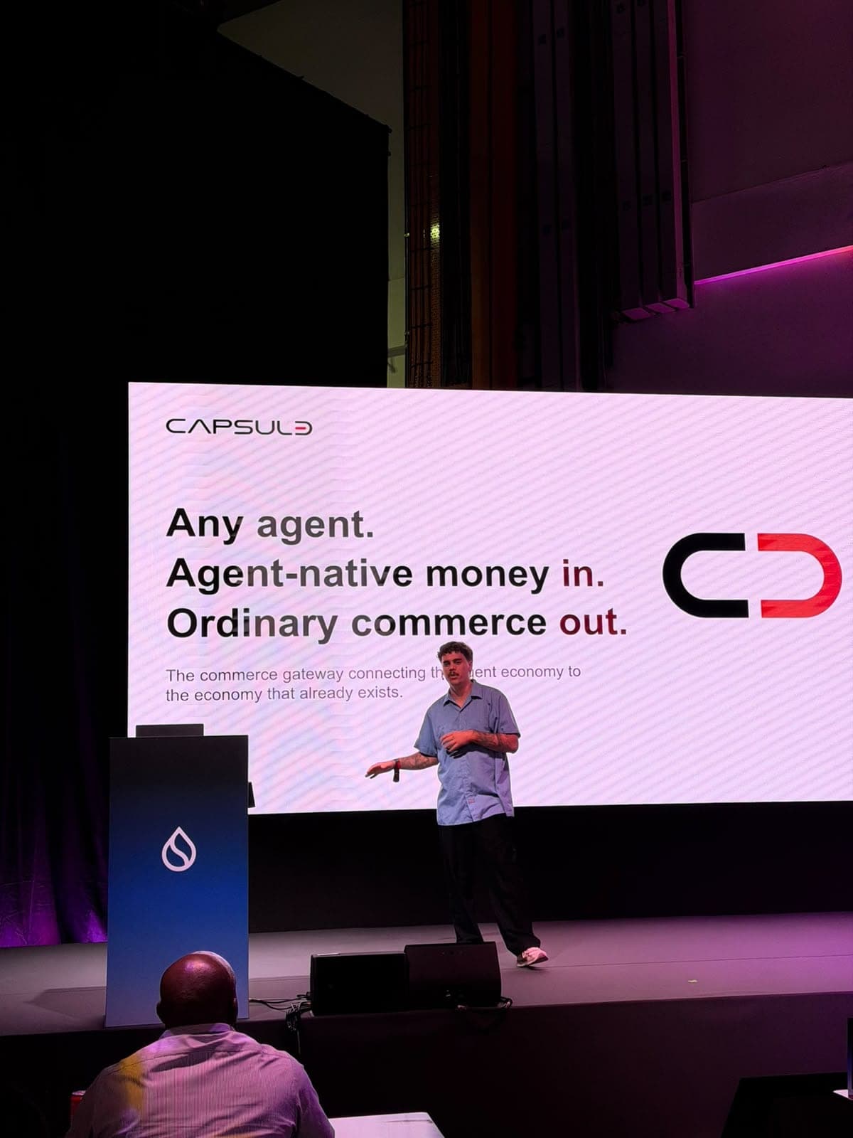 A hackathon builder presents Capsule, a commerce gateway for AI agents, on the main stage at Sui Basecamp.